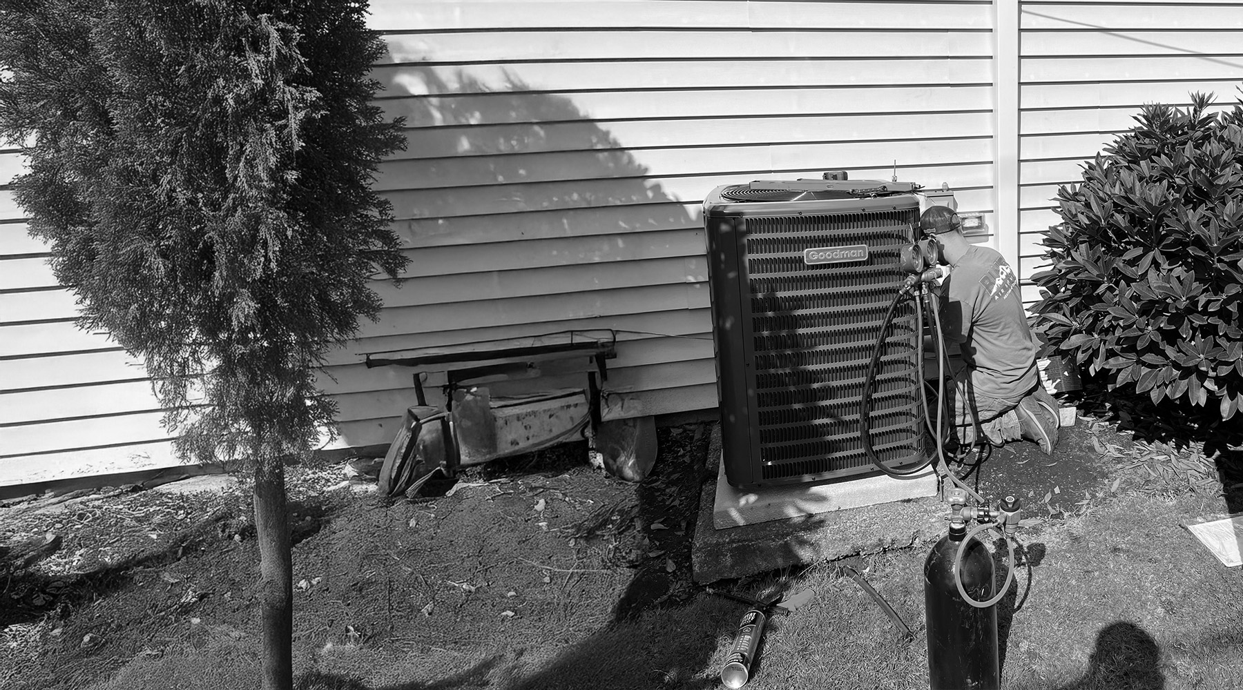 Blues Air HVAC tech checking Goodman condensor