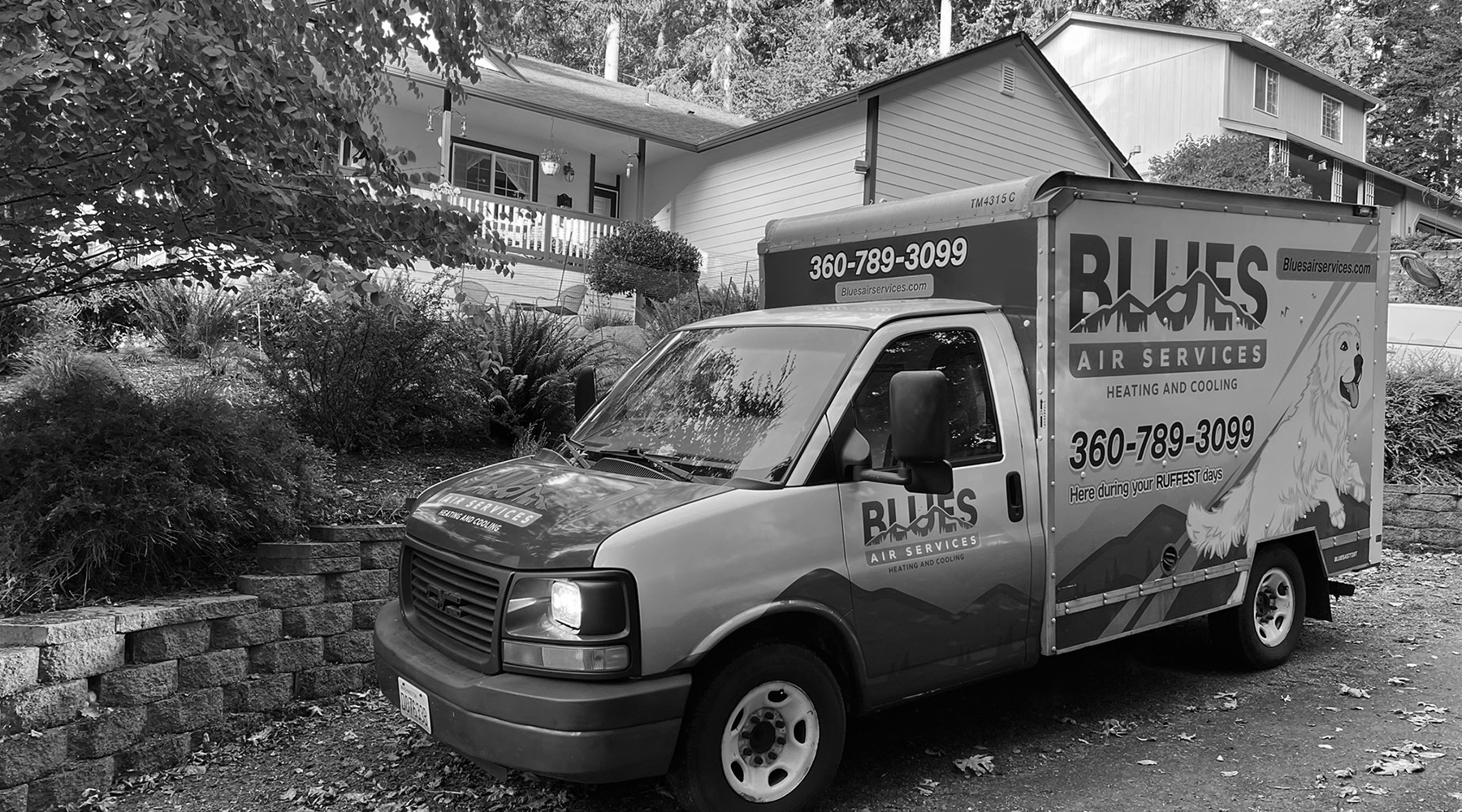 Blues branded van outside home