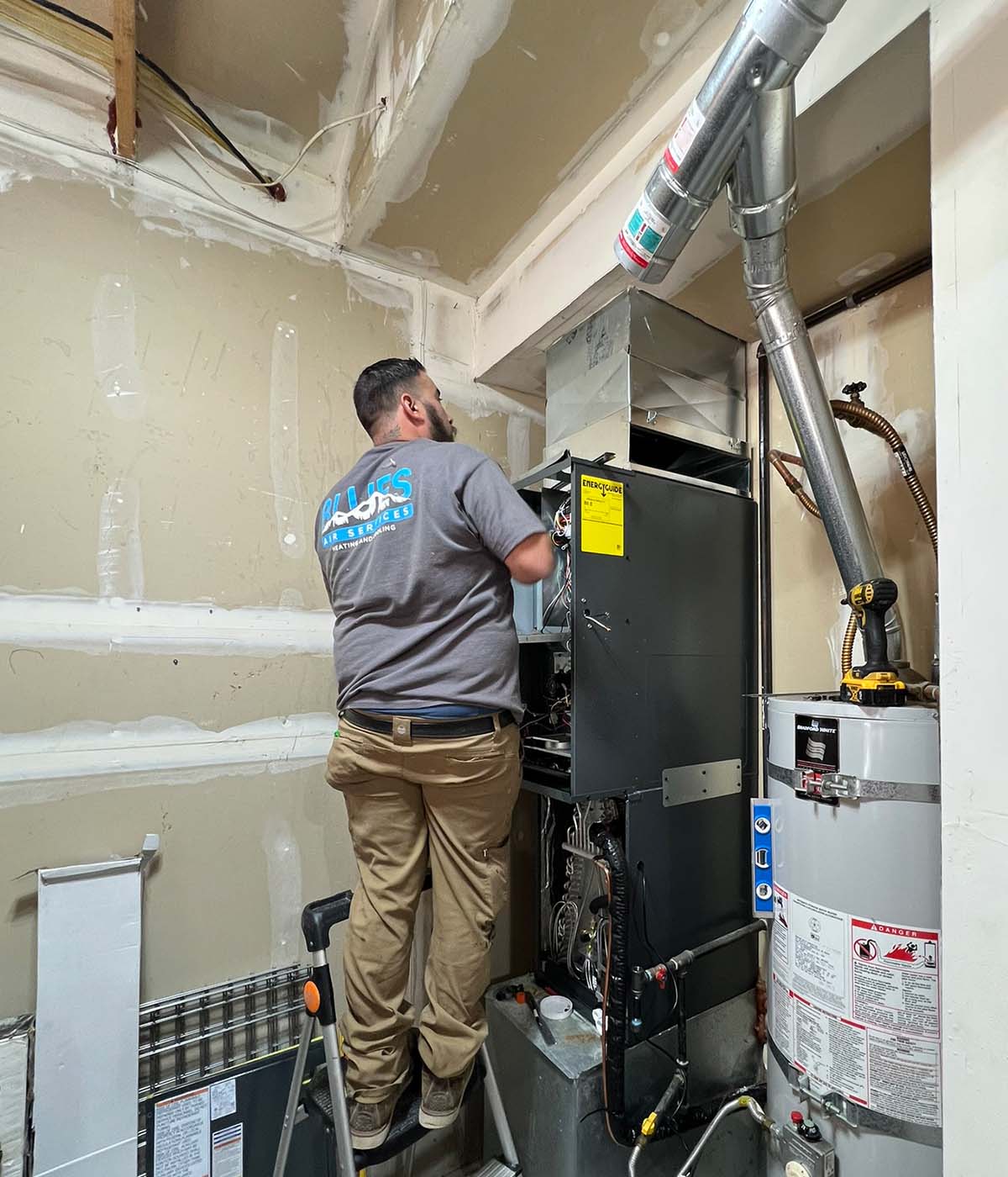 Blues tech fixing furnace