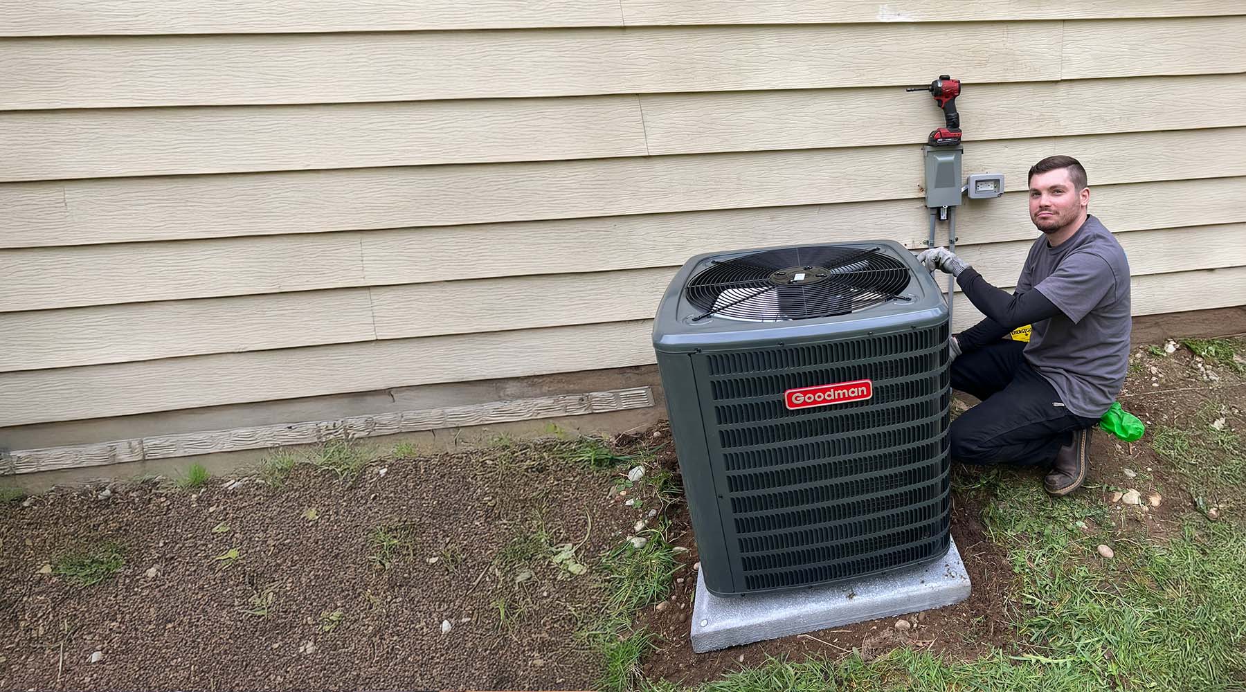 HVAC technician performing maintenance on an outdoor air conditioning system.