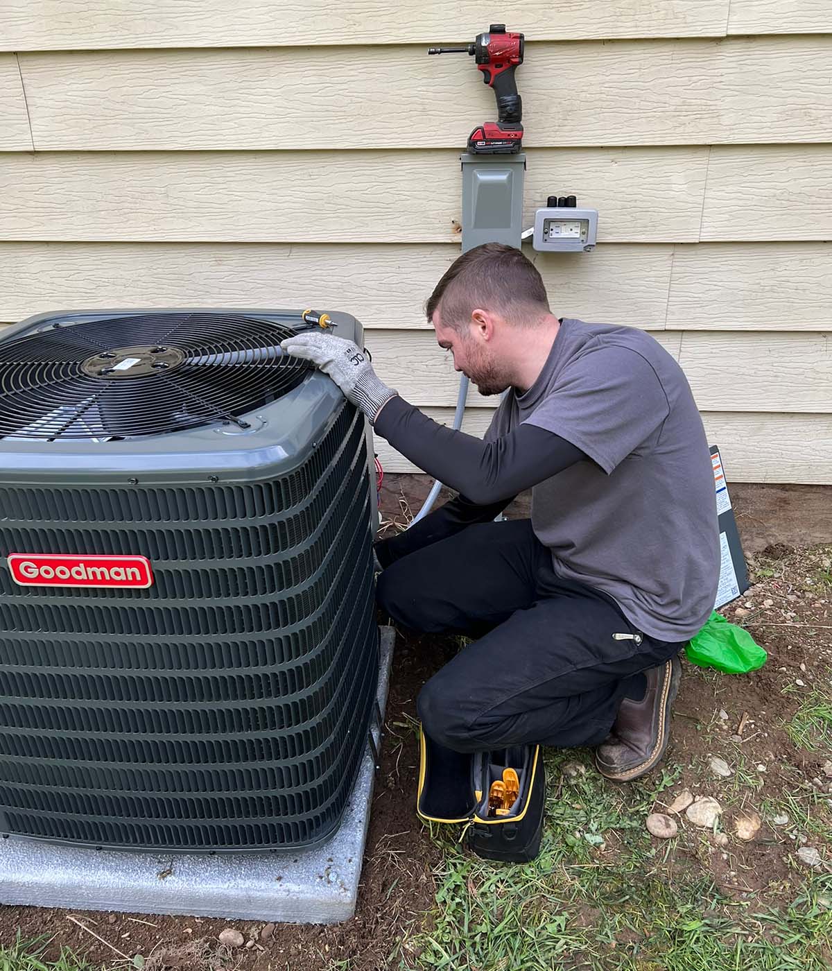 HVAC technician performing maintenance on an air conditioning system.